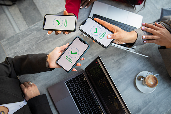 Women showing payment complete message on their phones